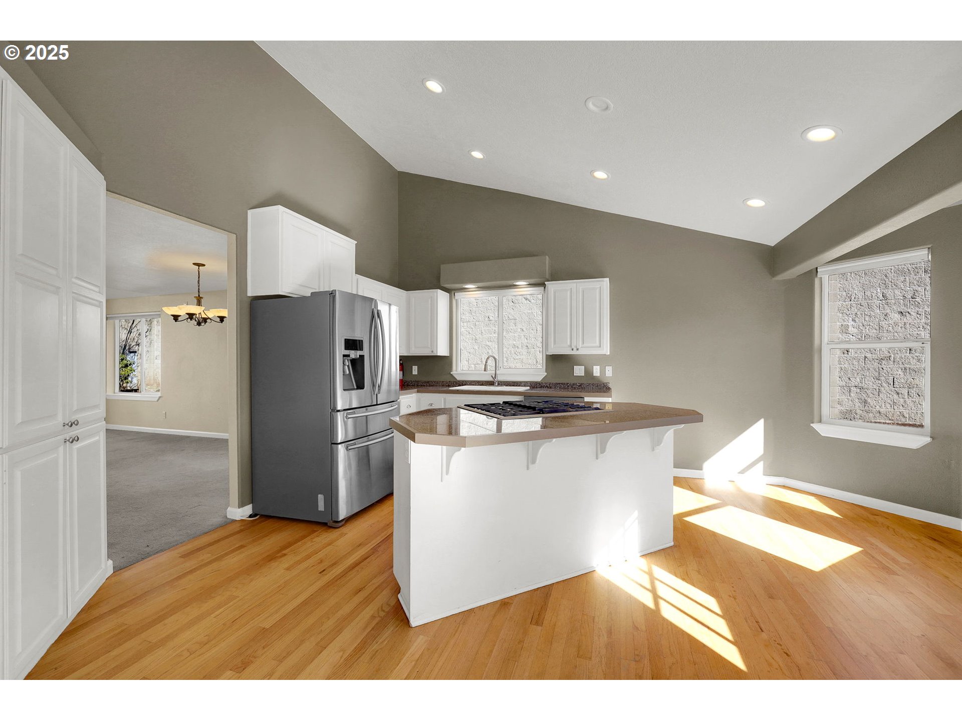 1587 Manchester Drive Eugene, OR 97401 - Photo 8 of 31 a kitchen with stainless steel appliances kitchen island granite countertop a refrigerator a sink a stove a microwave and island