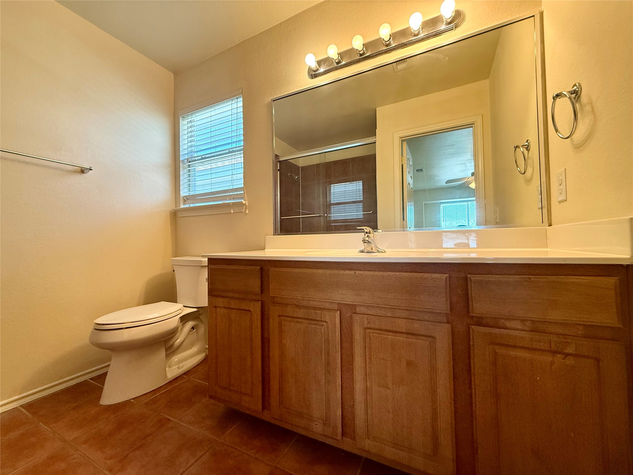 6912 Meador Avenue, Unit A Austin, TX 78752 - Photo 17 of 24 a bathroom with a toilet sink and mirror