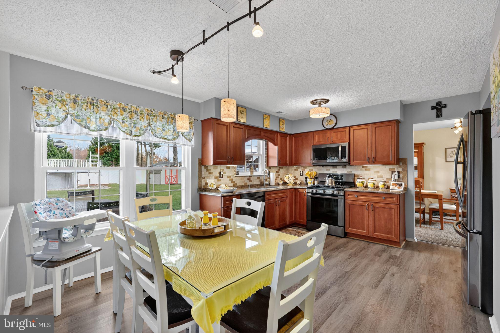11 Pony Run Sewell, NJ 08080 - Photo 11 of 33 a kitchen with a table chairs stove and refrigerator