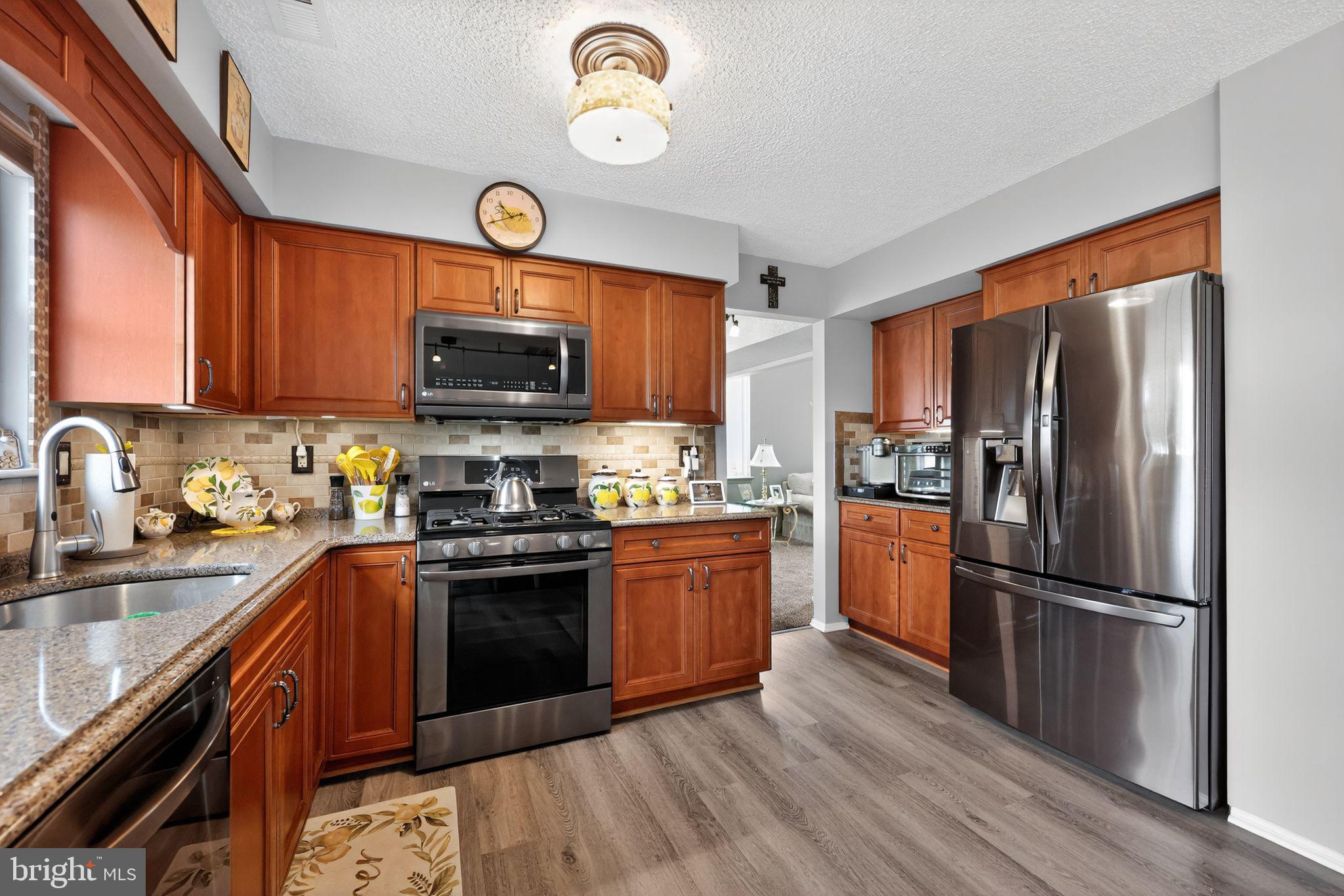 11 Pony Run Sewell, NJ 08080 - Photo 12 of 33 a kitchen with stainless steel appliances granite countertop a refrigerator a stove top oven a sink and dishwasher