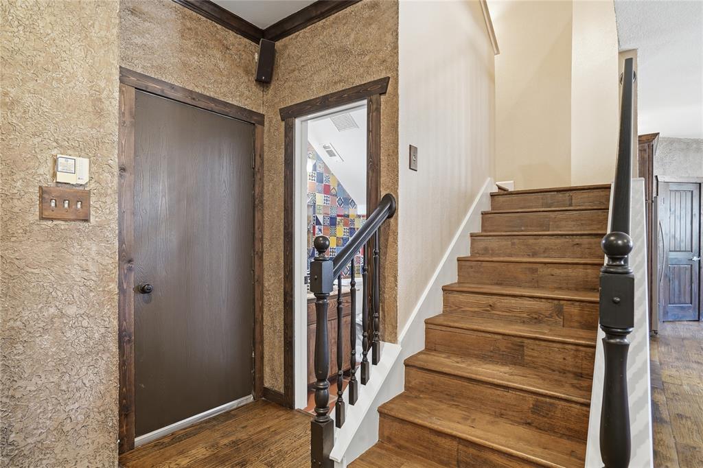 2133 Rustic Ridge Drive Keller, TX 76248 - Photo 15 of 40 Garage Entryway with stairway and dark wood-style flooring