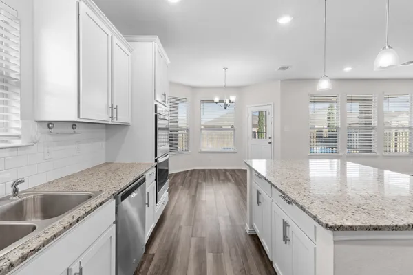 a kitchen with a sink stove and cabinets