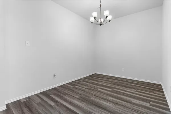 a view of a room with wooden floor and a ceiling fan