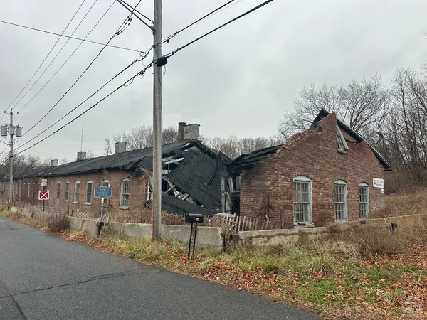 a brick house that has a street sign on it