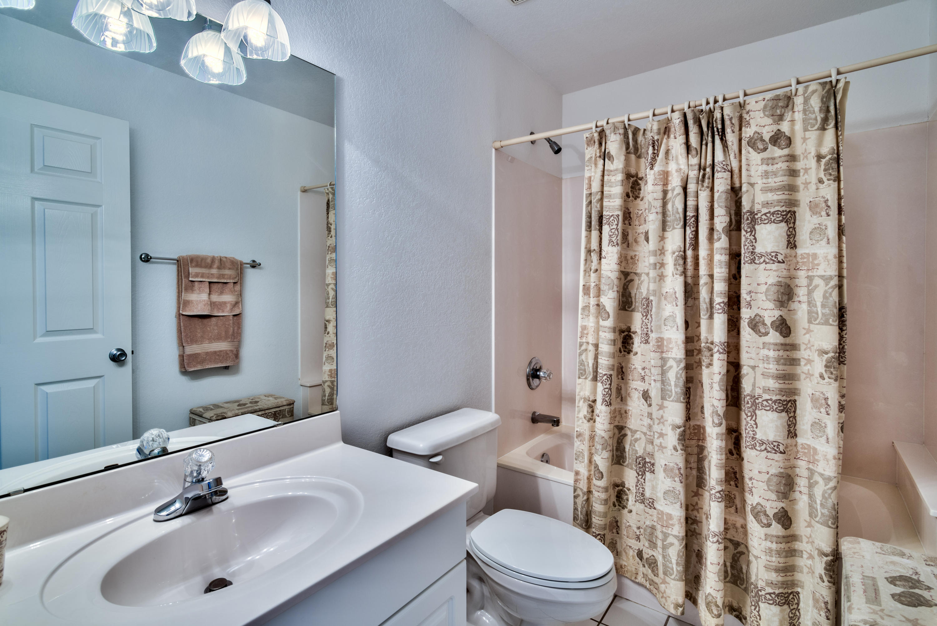 77 Legion Park Loop Miramar Beach, FL 32550 - Photo 25 of 25 a bathroom with a sink a toilet a mirror a vanity and shower curtain