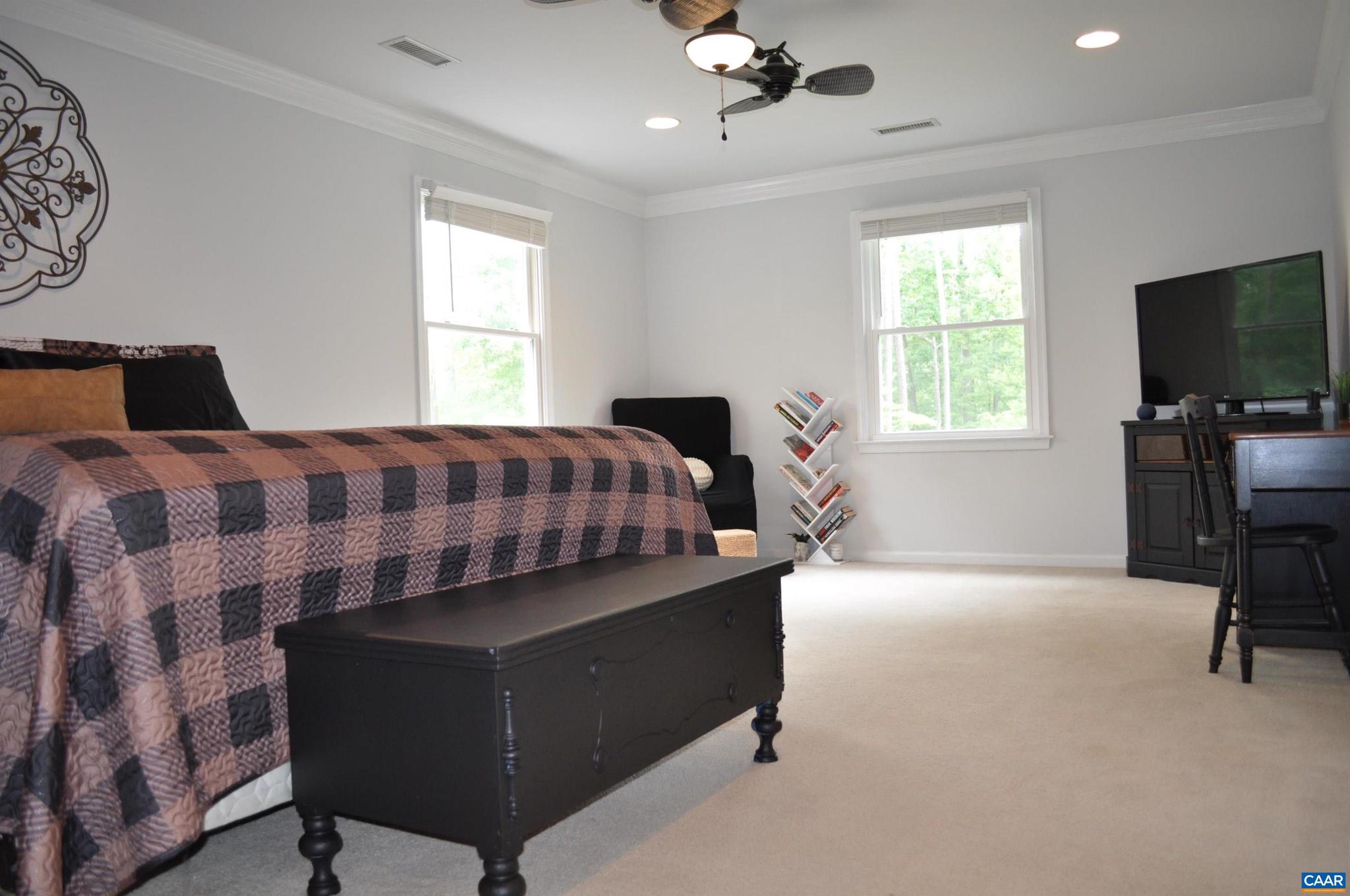 3257 Martin Kings Road Charlottesville, VA 22902 - Photo 22 of 49 a bedroom with a bed and a flat screen tv on the dresser