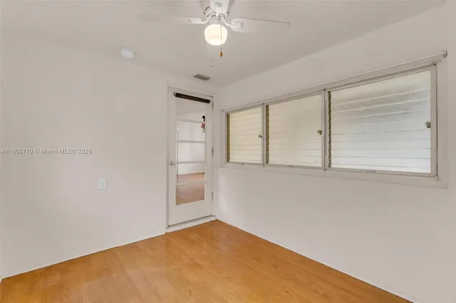 a view of empty room with ceiling fan