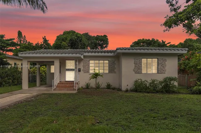a front view of a house with a garden