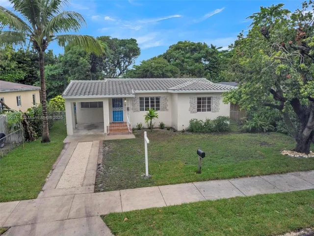 a front view of a house with a garden