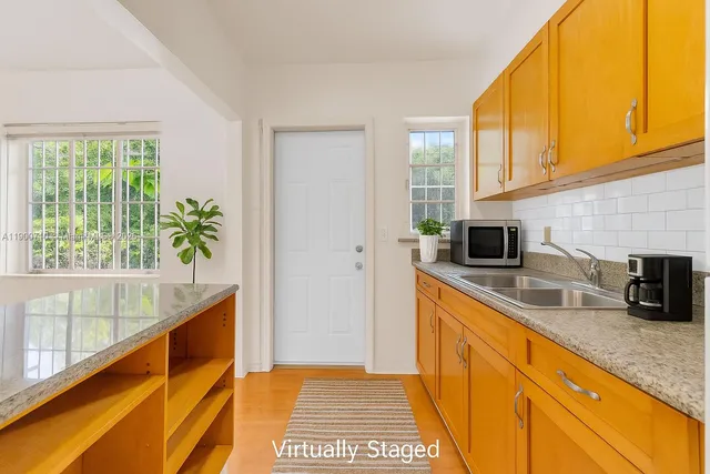 a kitchen with stainless steel appliances a sink a stove and a window