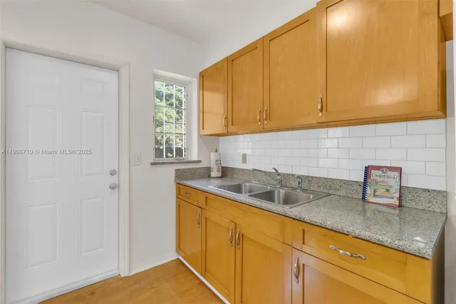 a kitchen with a sink and cabinets