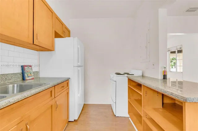 a kitchen with stainless steel appliances granite countertop a sink and dishwasher a stove top oven with wooden floor