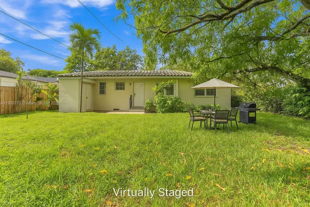 a swimming pool with outdoor seating and yard
