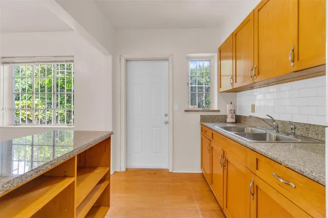 a kitchen with sink cabinets and wooden floor