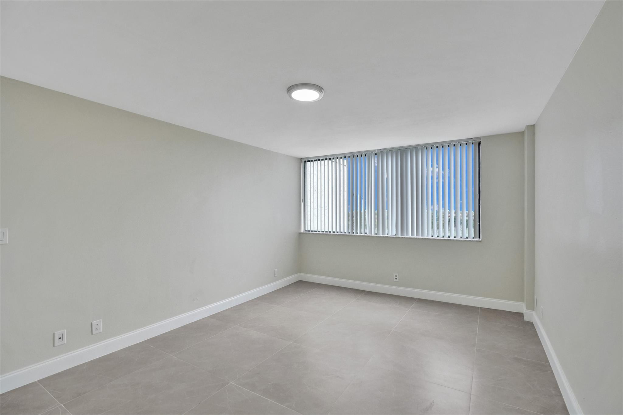 4222 Inverrary Boulevard, Unit 4810 Lauderhill, FL 33319 - Photo 47 of 63 wooden floor in an empty room with a window