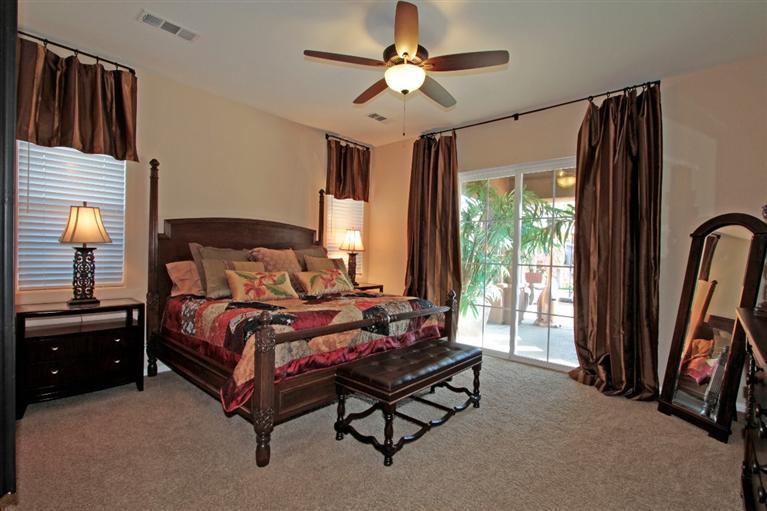 3 Via Santa Elena Rancho Mirage, CA 92270 - Photo 24 of 33 a bedroom with a bed and a chandelier
