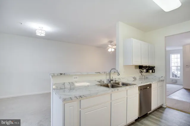 a kitchen with a sink cabinets and wooden floor