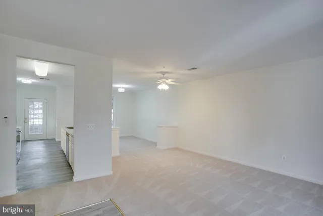 a view of an empty room and wooden floor