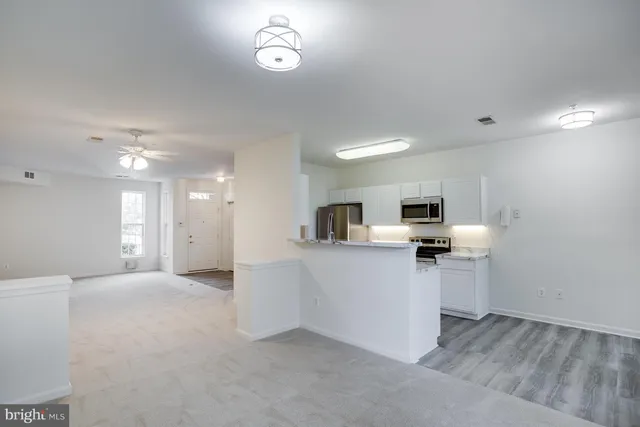 a view of kitchen with sink microwave and refrigerator