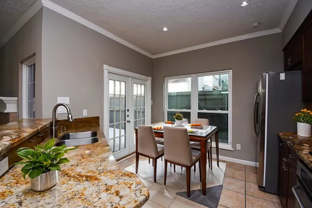 a dining room with furniture and wooden floor