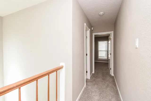 a view of a hallway with a white walls