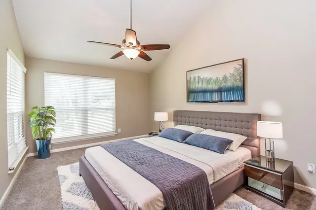 a bedroom with a bed and a window