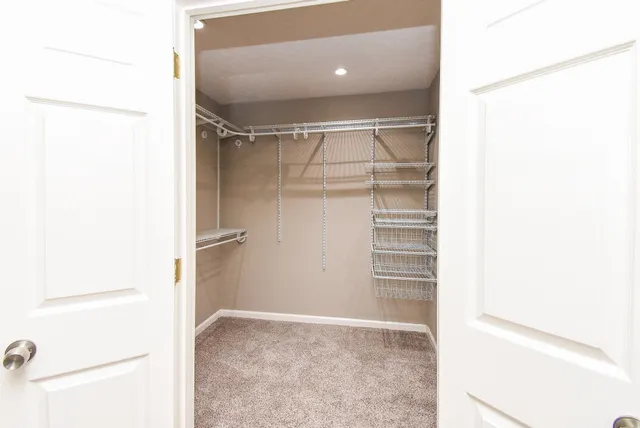 a view of walk in closet with empty racks