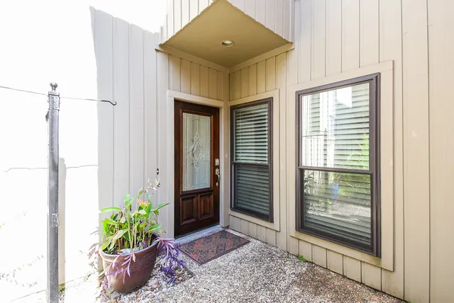 a front view of a house with potted plants
