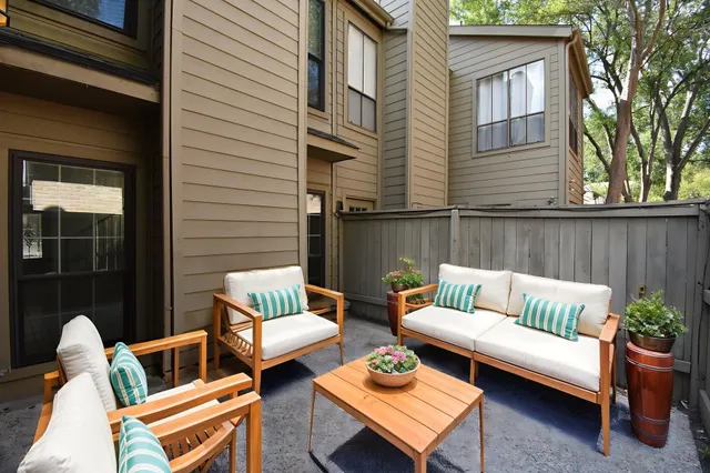 a view of a patio with couches chairs and a potted plant