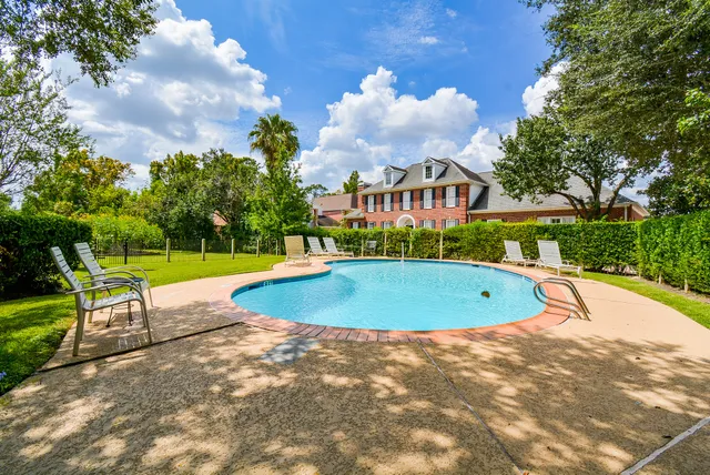 a view of a swimming pool and a yard