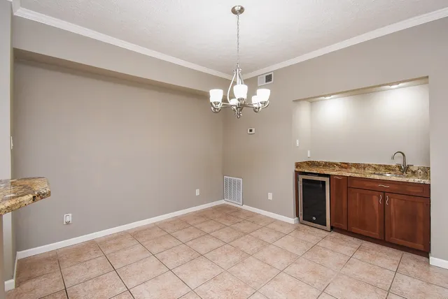a view of a kitchen with a sink and a chandelier