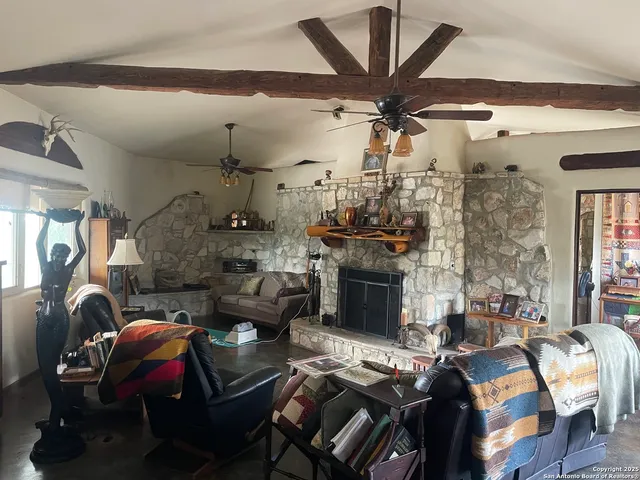 a bedroom with a bed couches and flat screen tv