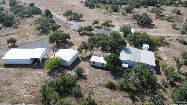 a view of a house with a backyard and garage