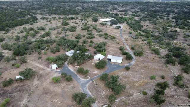 an aerial view of a house with a yard