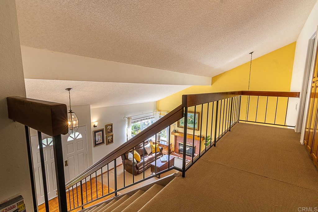 4738 Gateshead Road Carlsbad, CA 92010 - Photo 13 of 36 a view of staircase with lots of frames on wall and a window