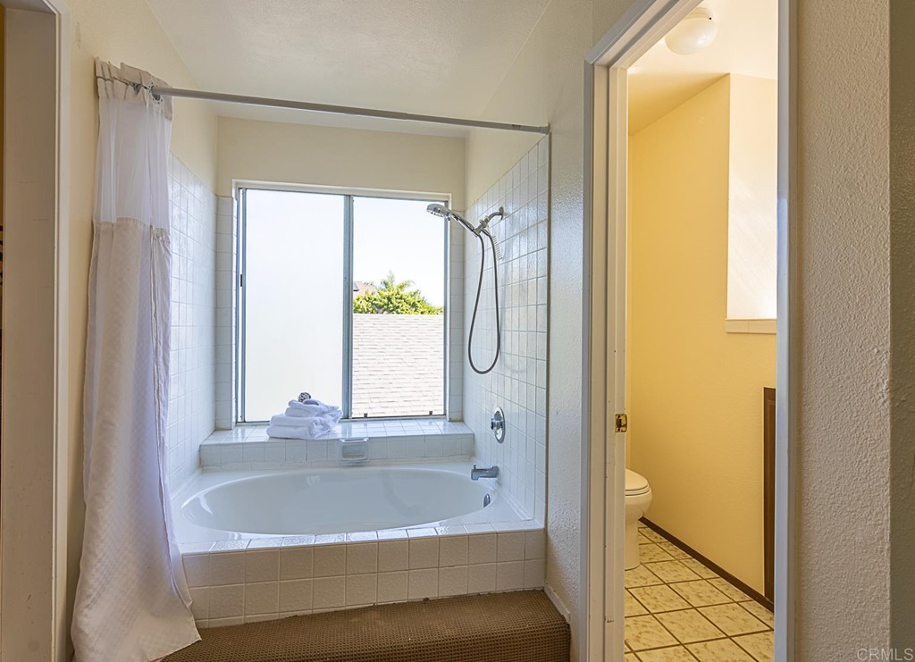 4738 Gateshead Road Carlsbad, CA 92010 - Photo 16 of 36 a bathroom with a bathtub and a shower