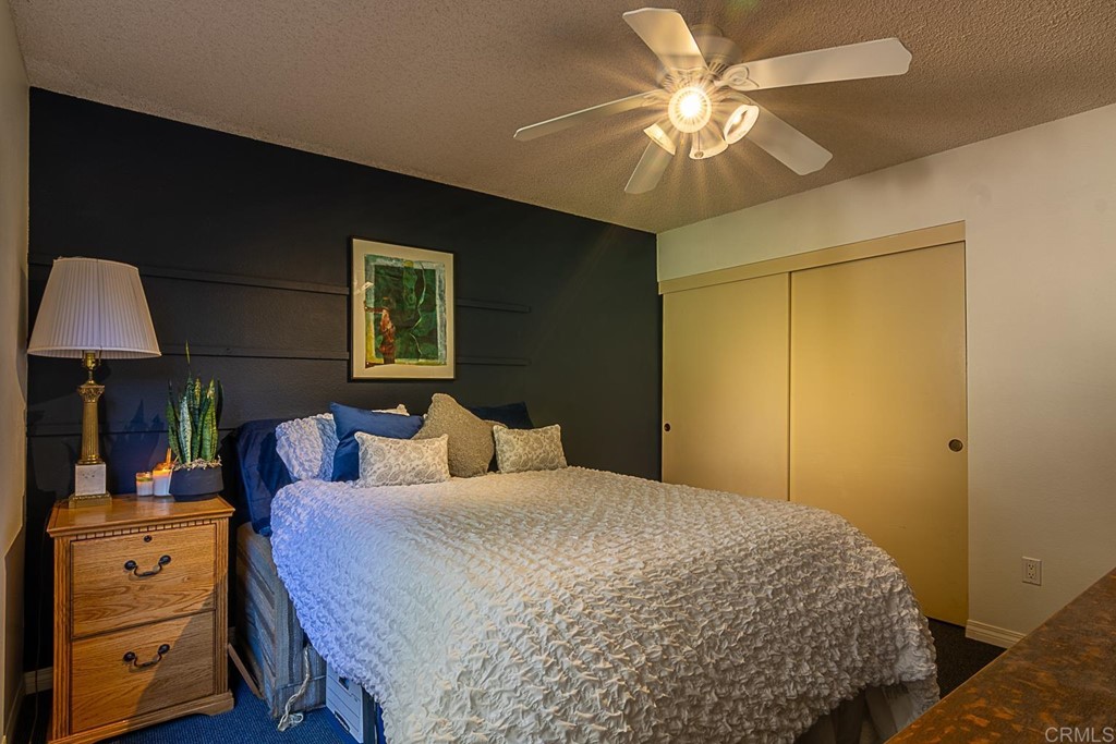 4738 Gateshead Road Carlsbad, CA 92010 - Photo 24 of 36 a bedroom with a bed and a chandelier