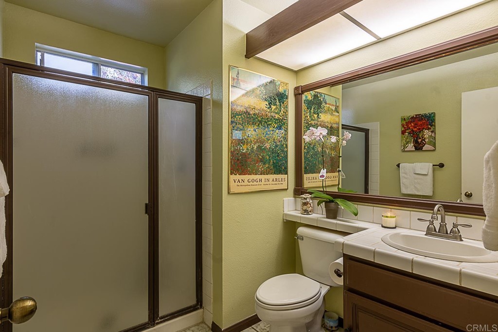 4738 Gateshead Road Carlsbad, CA 92010 - Photo 26 of 36 a bathroom with a granite countertop sink toilet and shower