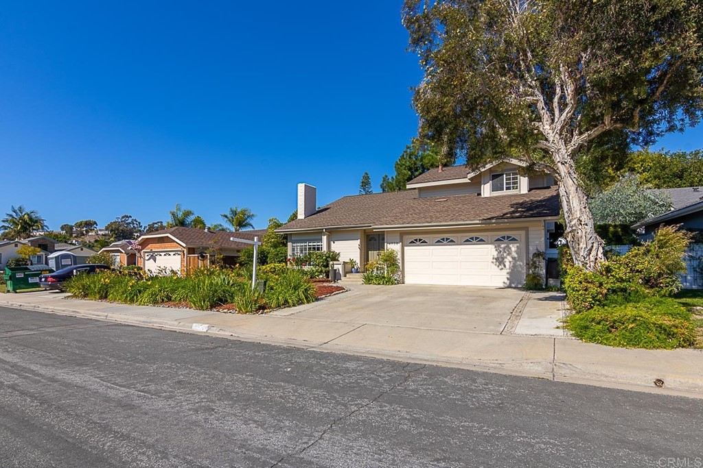 4738 Gateshead Road Carlsbad, CA 92010 - Photo 35 of 36 a front view of a house with a yard and garage