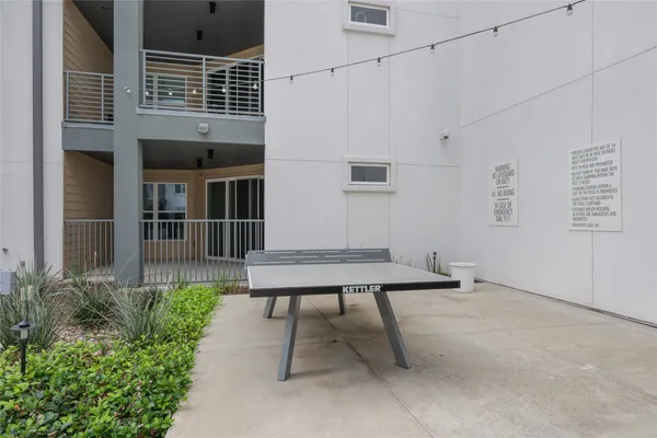 a view of a patio with table and chairs and potted plants