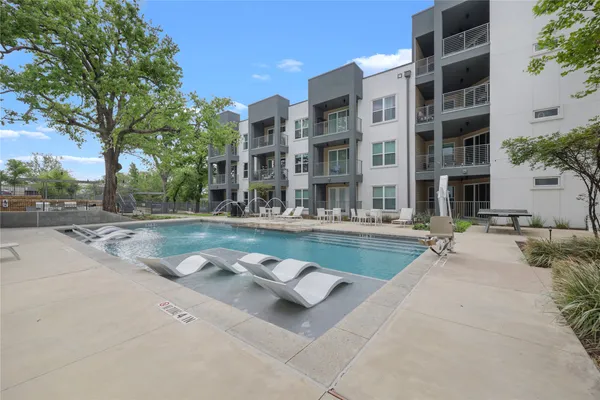 a swimming pool with outdoor seating and yard