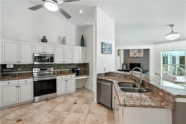 a large white kitchen with a large window