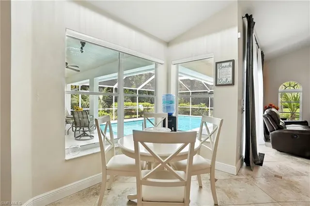a kitchen with white cabinets appliances and sink