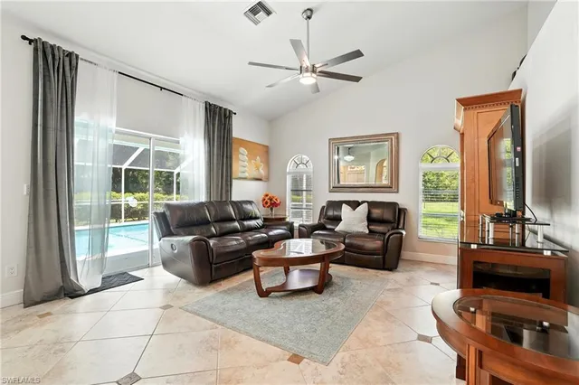 a living room with furniture and a view of kitchen