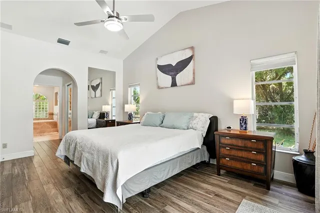 a bedroom with a large bed and a window