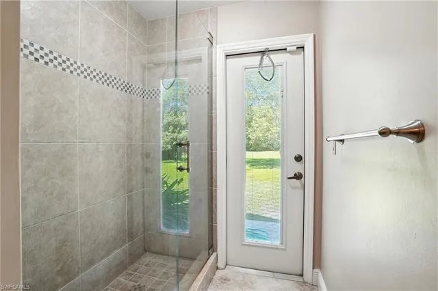 a spacious bathroom with a tub sink and mirror