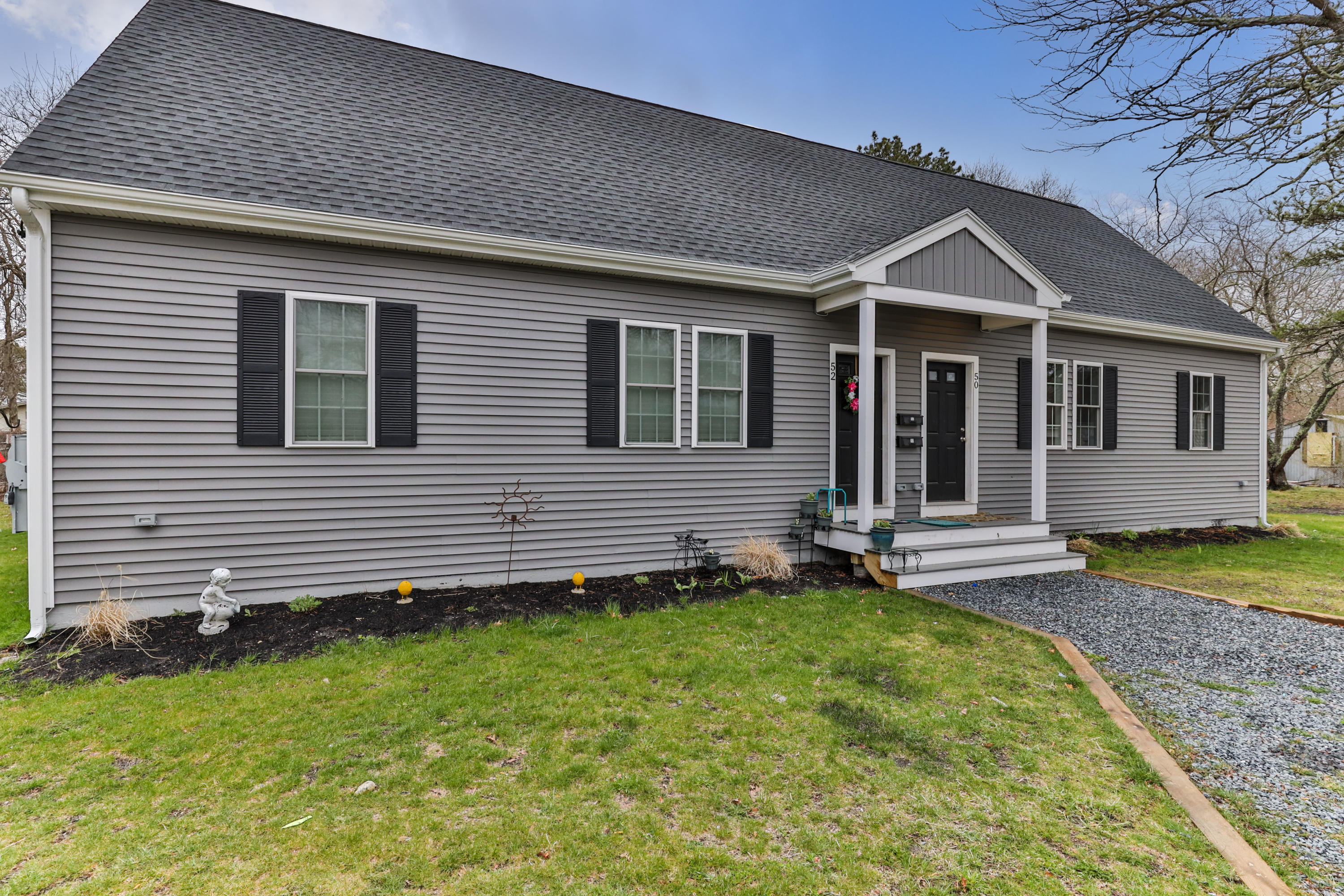 50 Fresh Holes Road, Unit 5052 Barnstable, MA 02601 - Photo 4 of 6 a view of a house with a yard
