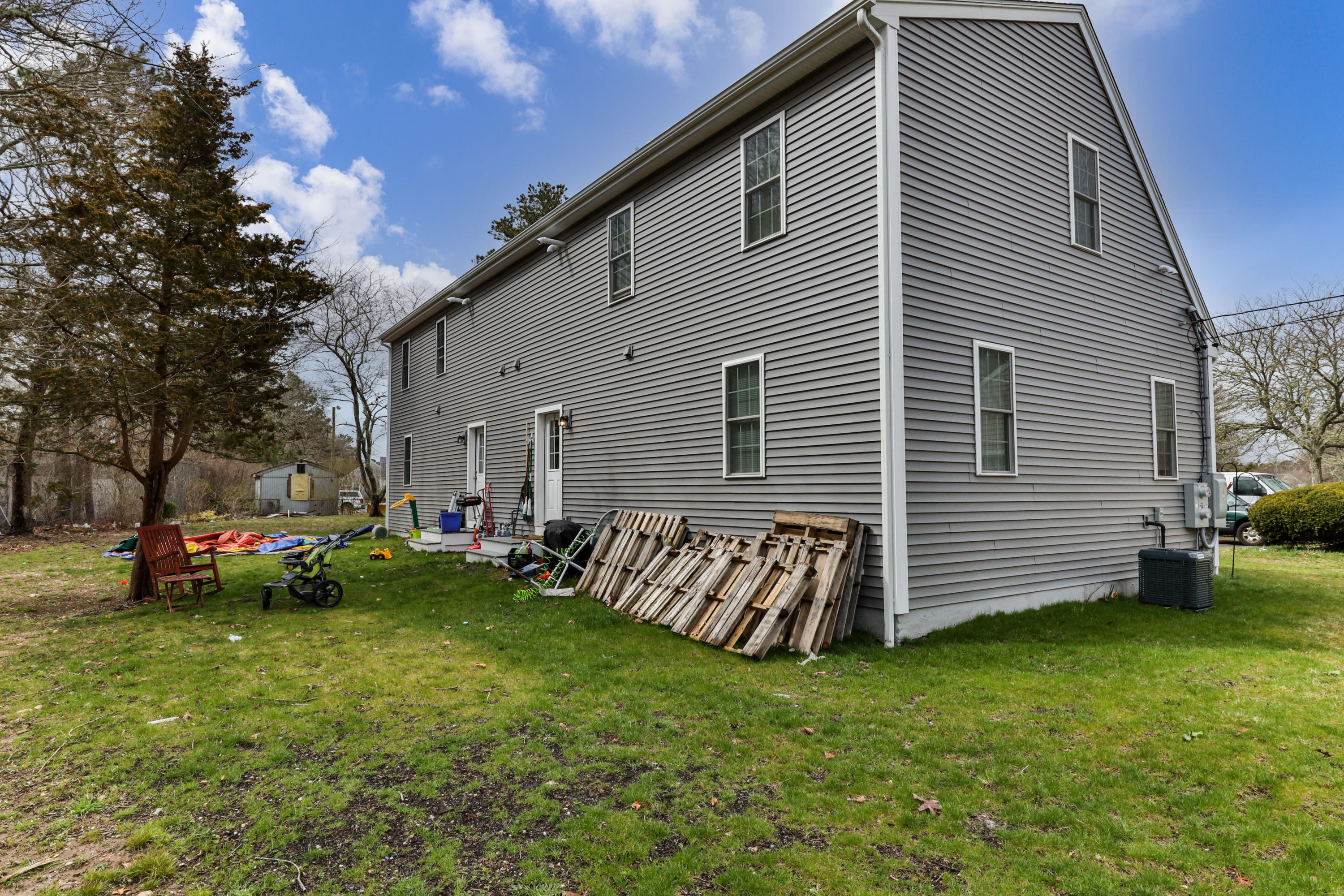 50 Fresh Holes Road, Unit 5052 Barnstable, MA 02601 - Photo 5 of 6 a view of a house with a yard and sitting area
