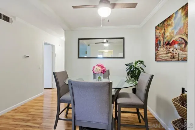 a view of a dining room with furniture and wooden floor
