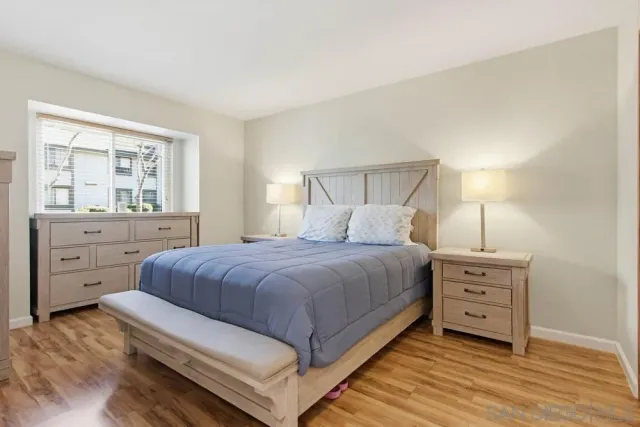 a bedroom with a bed and a night stand